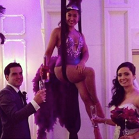Suspended  Champagne Pouring      Our gorgeous showgirls greet your guests and pour them a glass of champagne, all while suspended high above the ground on “silks”. A great way to make your event special.